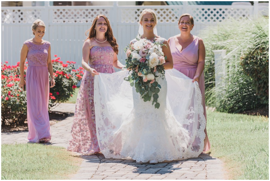 Bride and bridesmaids walk to her ceremony site at The Oaks by Melissa Grimes-Guy Photography
